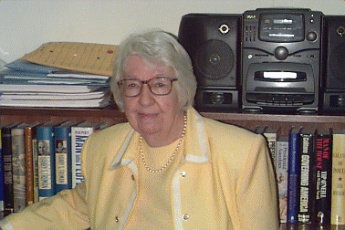 Blanche Coll in front of bookcase