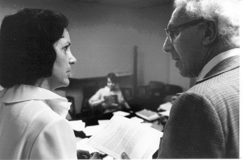 Myers and woman looking at document